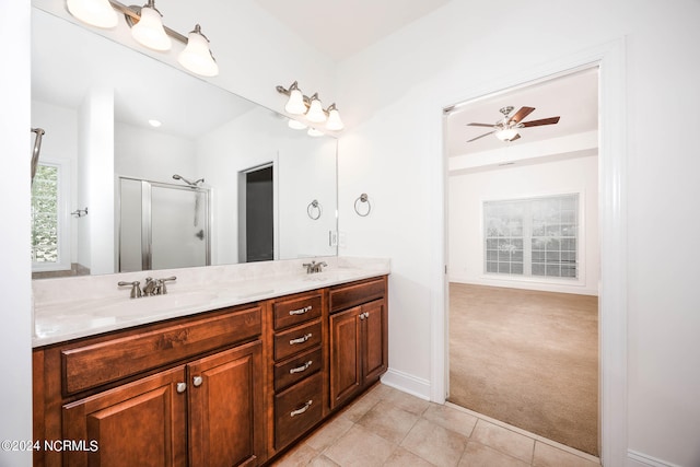 bathroom with tile patterned floors, a shower with shower door, ceiling fan, and vanity