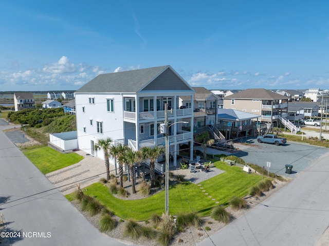 view of building exterior with a residential view and driveway