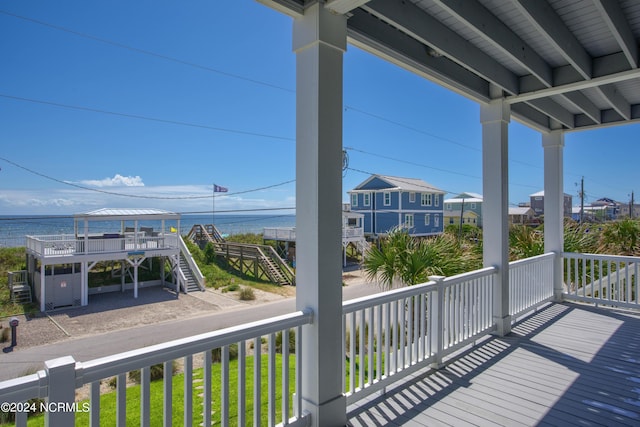 wooden terrace featuring a water view