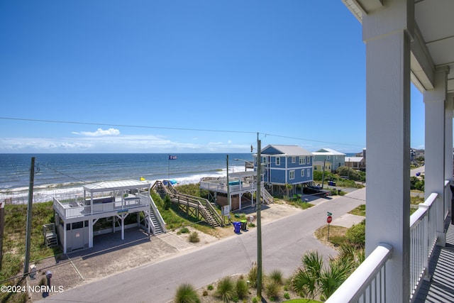 water view with stairs and a view of the beach