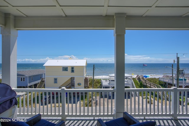 balcony featuring area for grilling, a beach view, and a water view