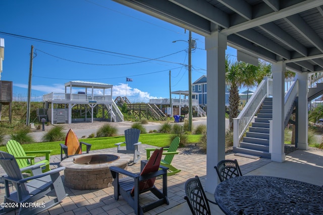 view of patio with a fire pit and stairway