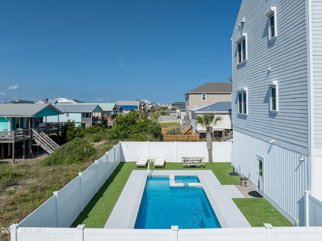 view of swimming pool with a fenced backyard, a residential view, stairway, a yard, and a patio area