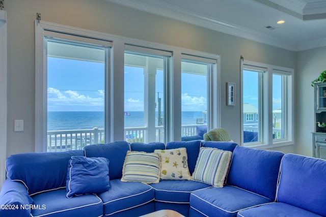 living room featuring recessed lighting, a water view, crown molding, and visible vents