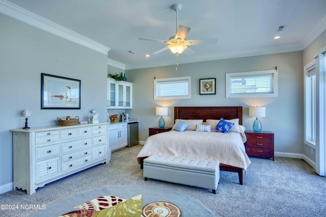 bedroom featuring light colored carpet, crown molding, baseboards, and multiple windows