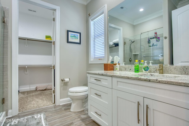 full bathroom featuring a spacious closet, vanity, a shower stall, and visible vents