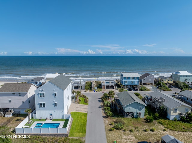 birds eye view of property featuring a residential view, a water view, and a beach view