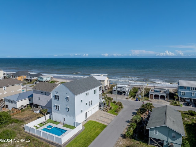 aerial view with a water view and a beach view