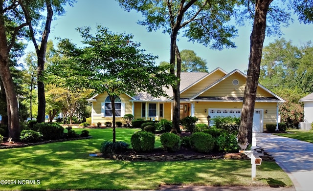 single story home with concrete driveway, an attached garage, and a front lawn