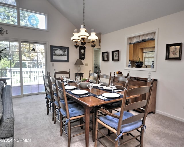 dining area featuring light carpet, high vaulted ceiling, baseboards, and an inviting chandelier