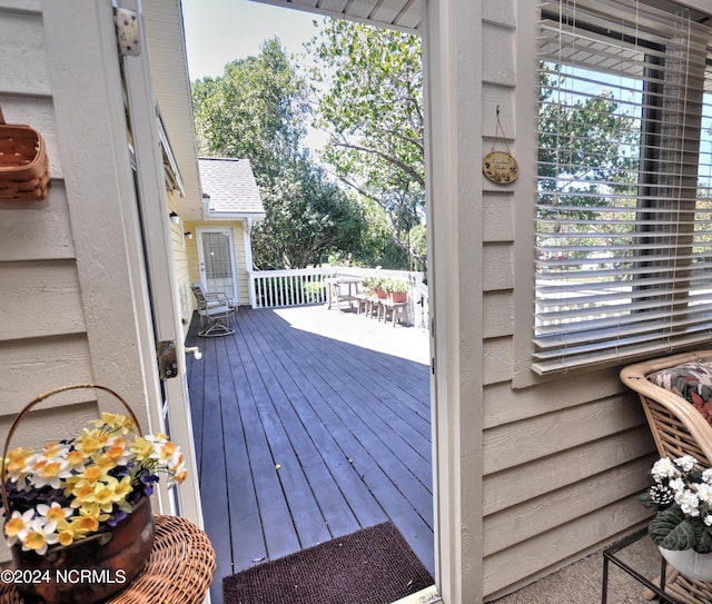 wooden terrace with outdoor dining area