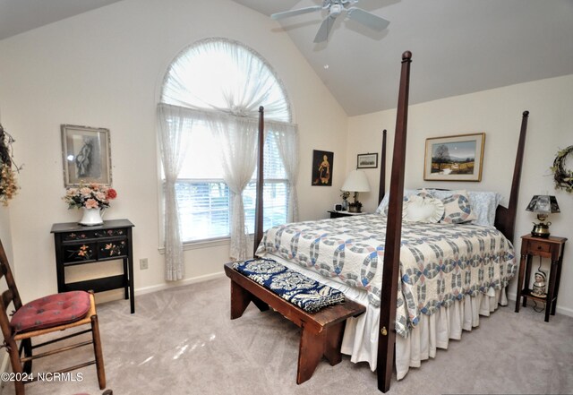 bedroom with ceiling fan, light carpet, and vaulted ceiling