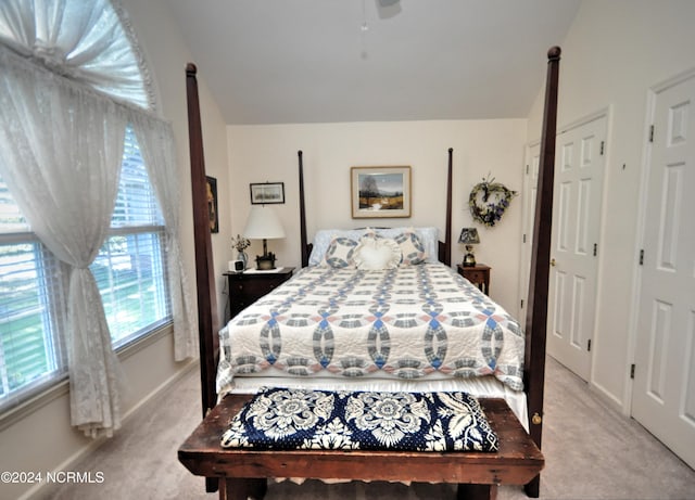 bedroom featuring lofted ceiling, carpet, and baseboards