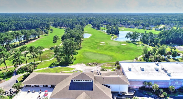 birds eye view of property with view of golf course and a forest view