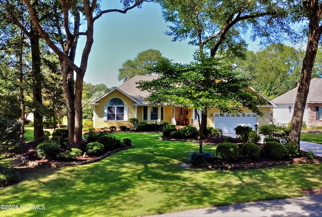 view of front of property featuring a garage, a porch, and a front lawn