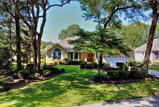 view of front facade with a front lawn and an attached garage