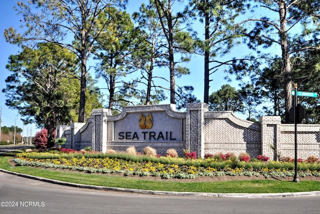 community sign featuring fence