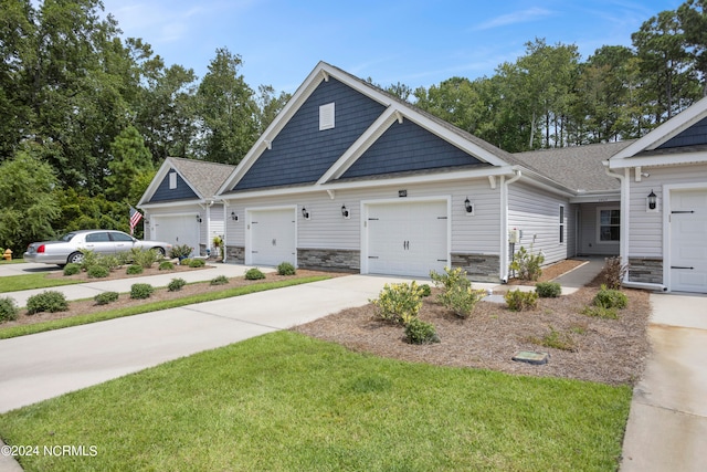 craftsman-style home featuring a front yard and a garage