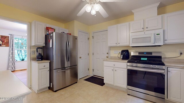 kitchen with ceiling fan, appliances with stainless steel finishes, and white cabinets