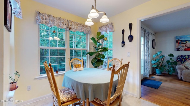 dining space featuring plenty of natural light, a chandelier, and light hardwood / wood-style flooring