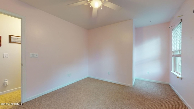 unfurnished room featuring ceiling fan and light carpet