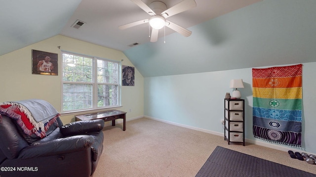 living area featuring vaulted ceiling, ceiling fan, and carpet flooring