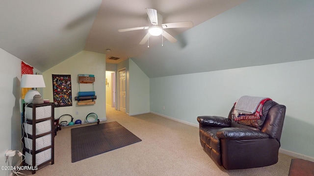 living area featuring vaulted ceiling, light carpet, and ceiling fan