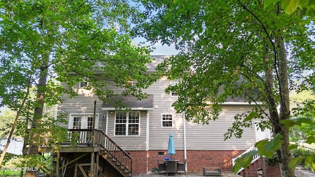 back of house with a wooden deck