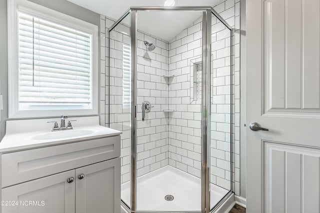 bathroom featuring an enclosed shower and vanity