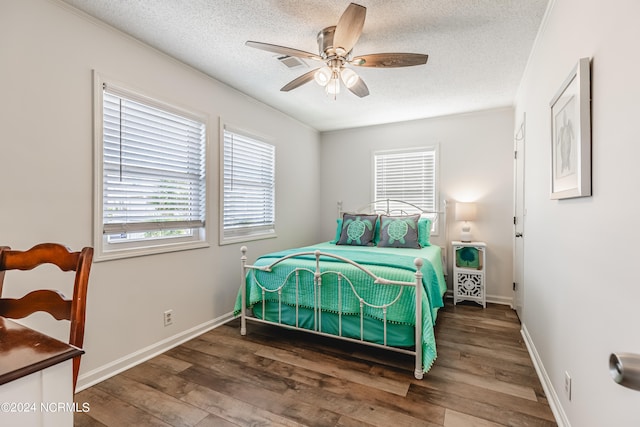 bedroom featuring a textured ceiling, ceiling fan, and dark hardwood / wood-style floors