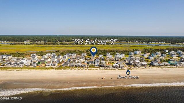 bird's eye view featuring a view of the beach and a water view