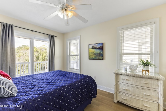 bedroom featuring ceiling fan, baseboards, and wood finished floors