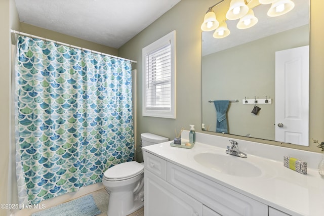 bathroom with a textured ceiling, toilet, a notable chandelier, vanity, and tile patterned floors