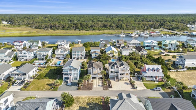 aerial view featuring a water view, a forest view, and a residential view