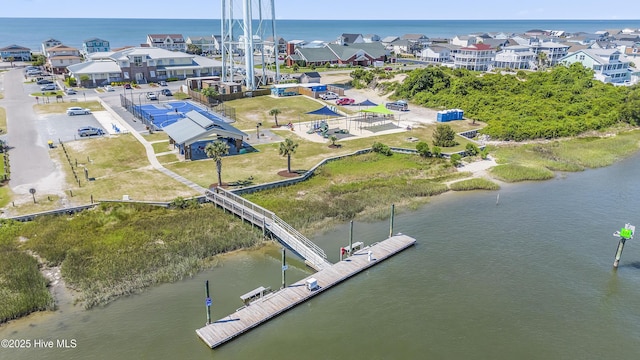 drone / aerial view featuring a water view and a residential view