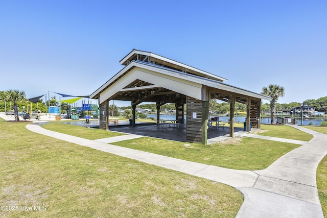 surrounding community with a water view, a yard, and a gazebo