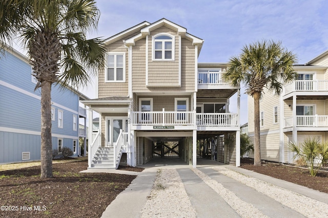 coastal home featuring driveway and a carport