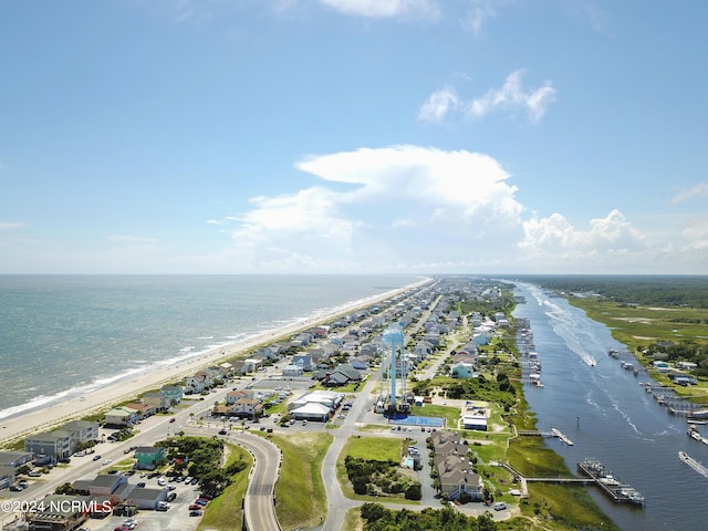 birds eye view of property featuring a beach view and a water view