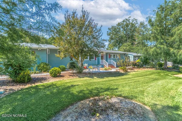 ranch-style home with a front lawn