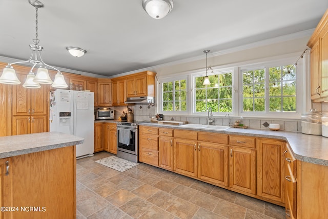 kitchen featuring decorative backsplash, pendant lighting, stainless steel range with electric stovetop, sink, and white refrigerator with ice dispenser