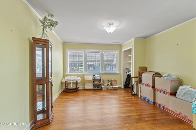 recreation room featuring ornamental molding and wood-type flooring