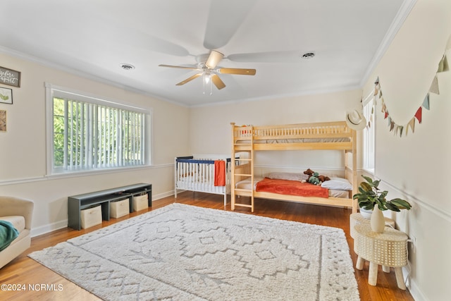 bedroom featuring ornamental molding, hardwood / wood-style flooring, and ceiling fan