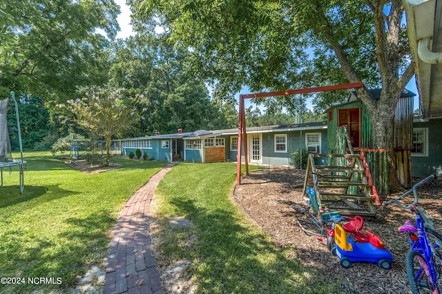 exterior space with a front lawn and a playground