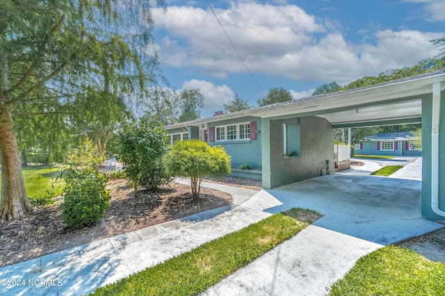 view of side of home with a carport