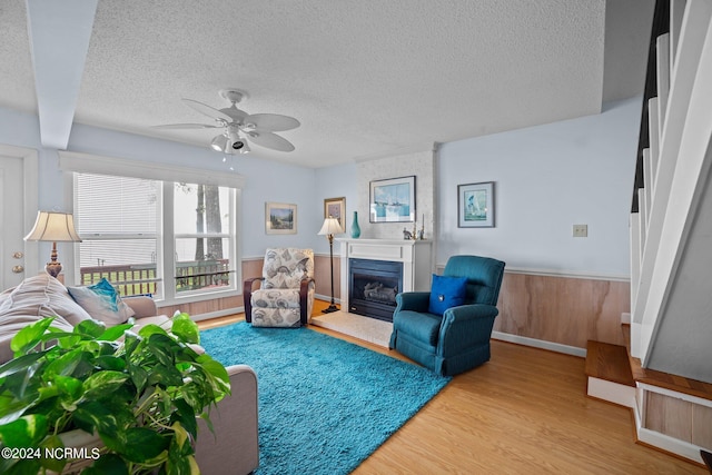 interior space featuring a glass covered fireplace and ceiling fan