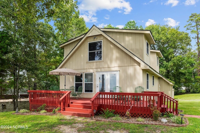 back of house featuring a deck and a yard