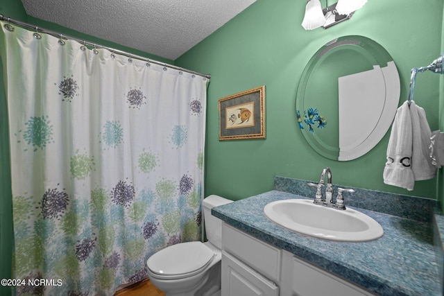 full bath with a textured ceiling, vanity, toilet, and a shower with curtain