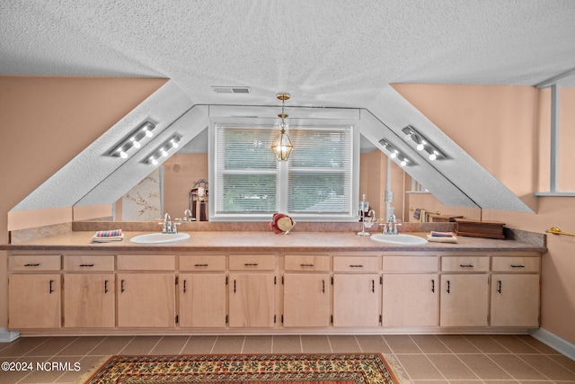 interior space featuring double vanity, a textured ceiling, visible vents, and a sink