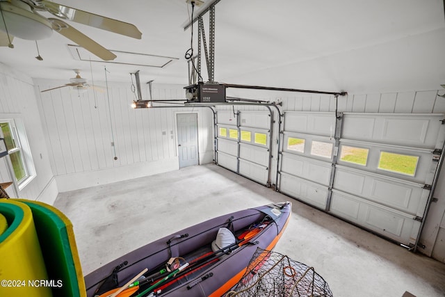 garage with a garage door opener and ceiling fan