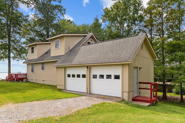 view of side of home featuring dirt driveway, a lawn, roof with shingles, crawl space, and an attached garage